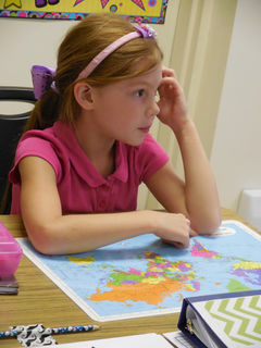 A student engages in a classroom activity at Community Christian Academy