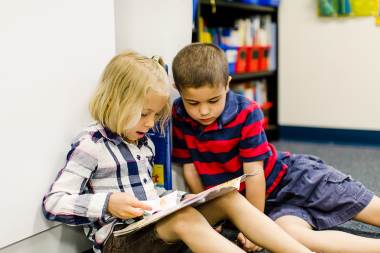 Two Community Christian Academy students engage with their learning material.