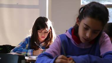 Two Community Christian Academy students engage in classwork
