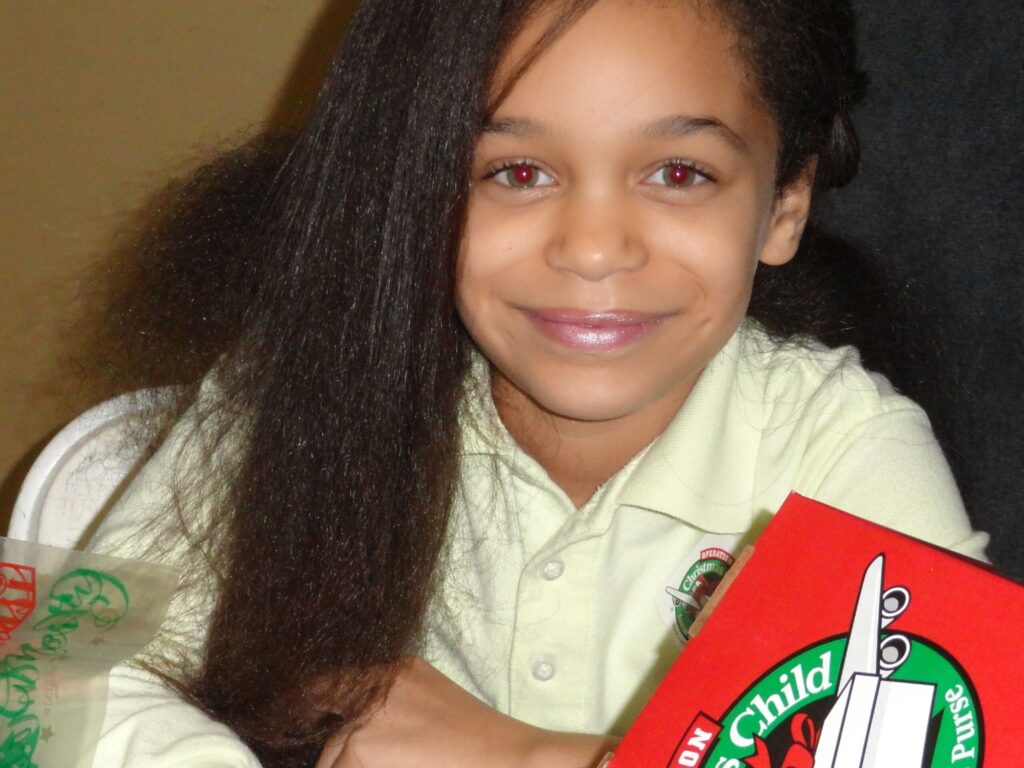 A Community Christian Academy student prepares an Operation Christmas Child shoebox
