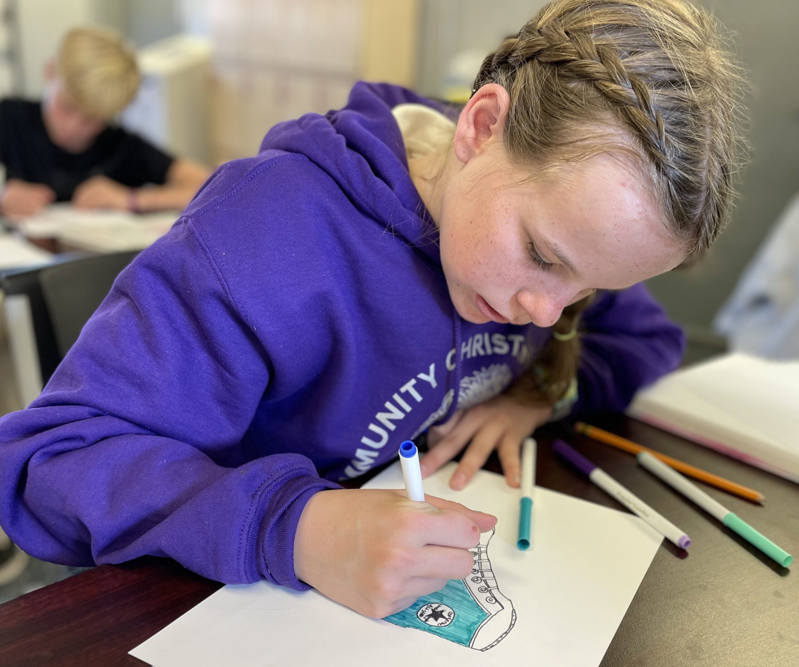 A student writes in a workbook