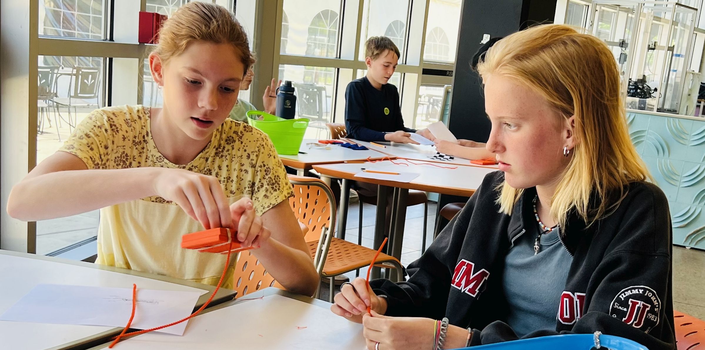 Two girls engaging in an educational activity at a science museum