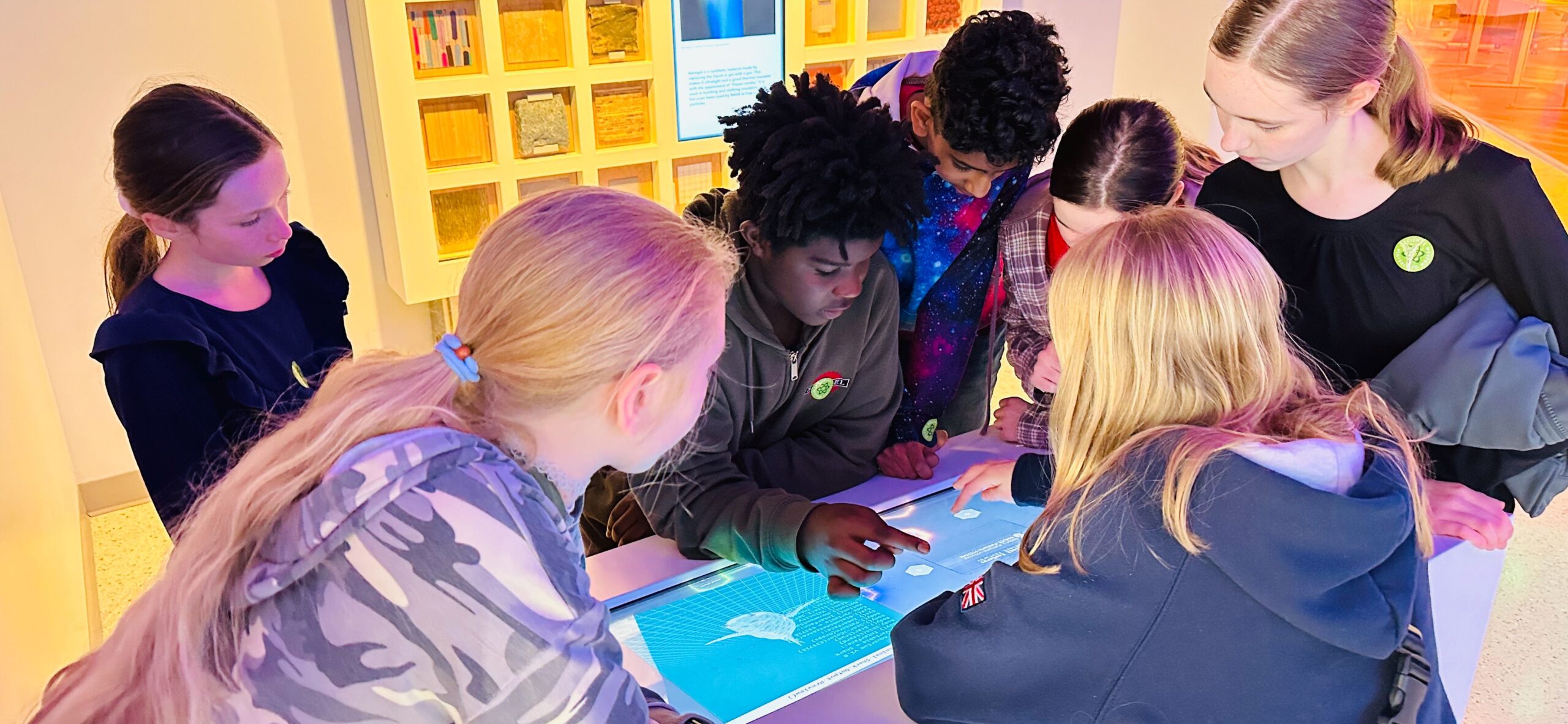 Students interact with a digital display at a museum