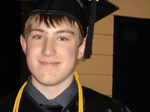 Boy attired in graduation regalia