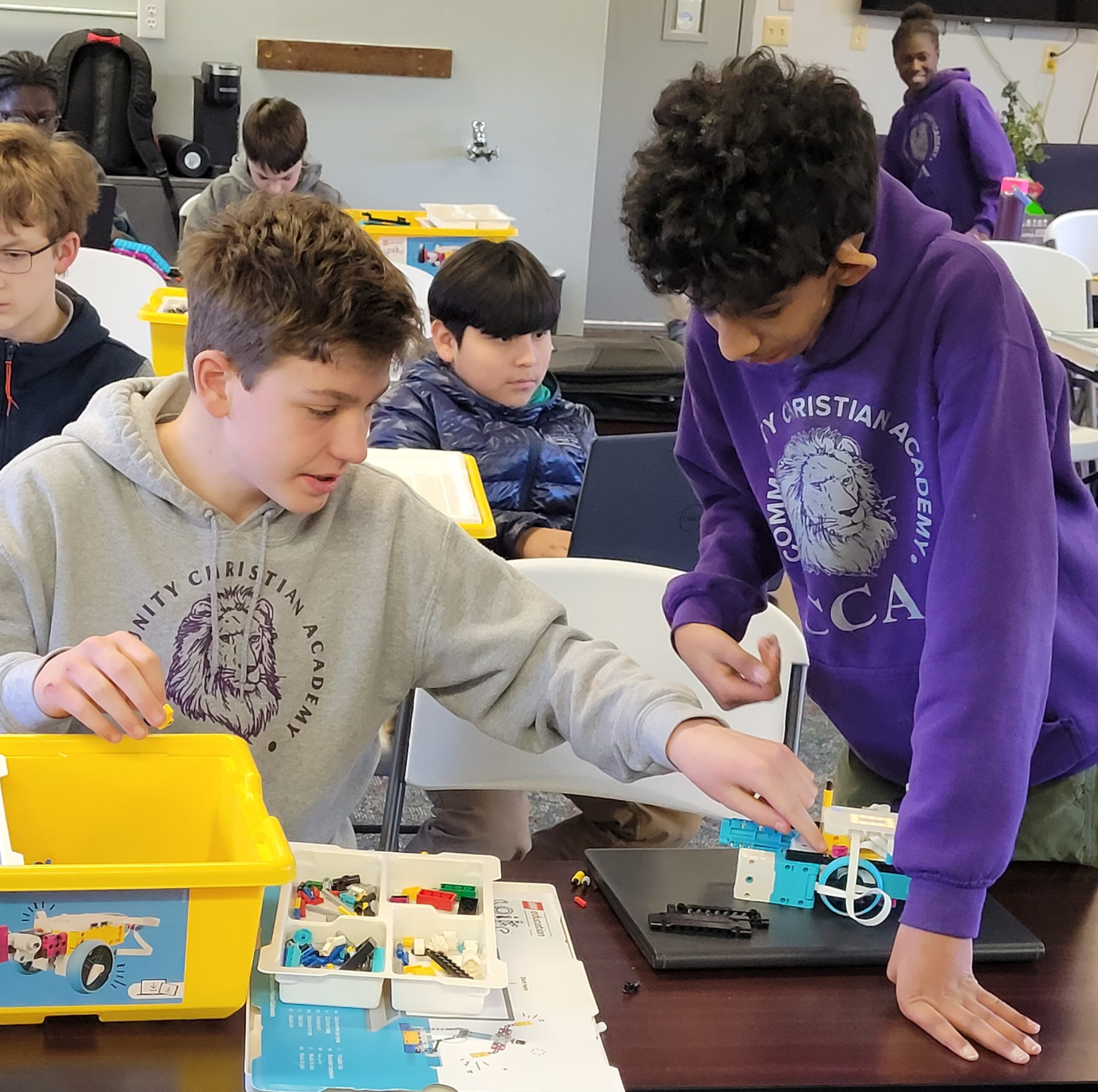 Students building robots with LEGO bricks