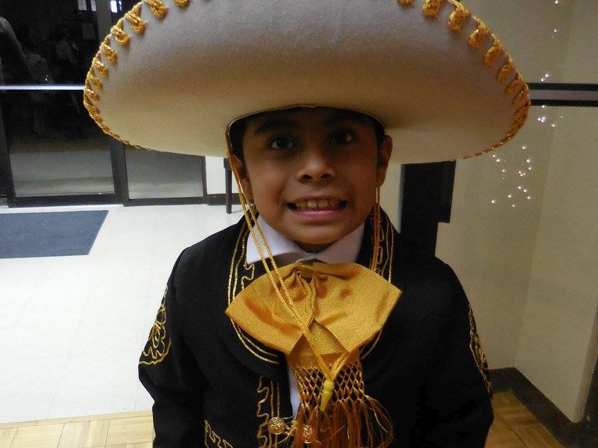 A child is wearing a sombrero