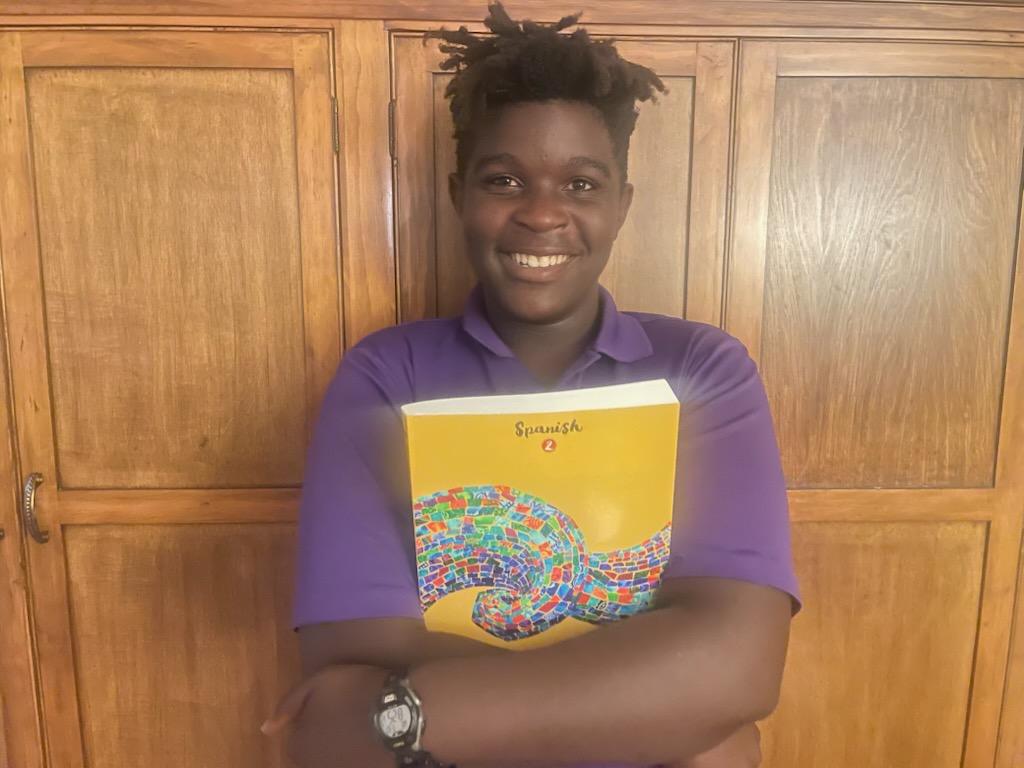 CCA student holds a Spanish textbook
