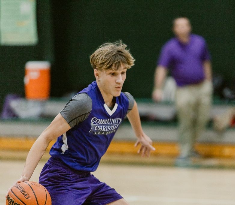 A Community Christian Academy student plays basketball