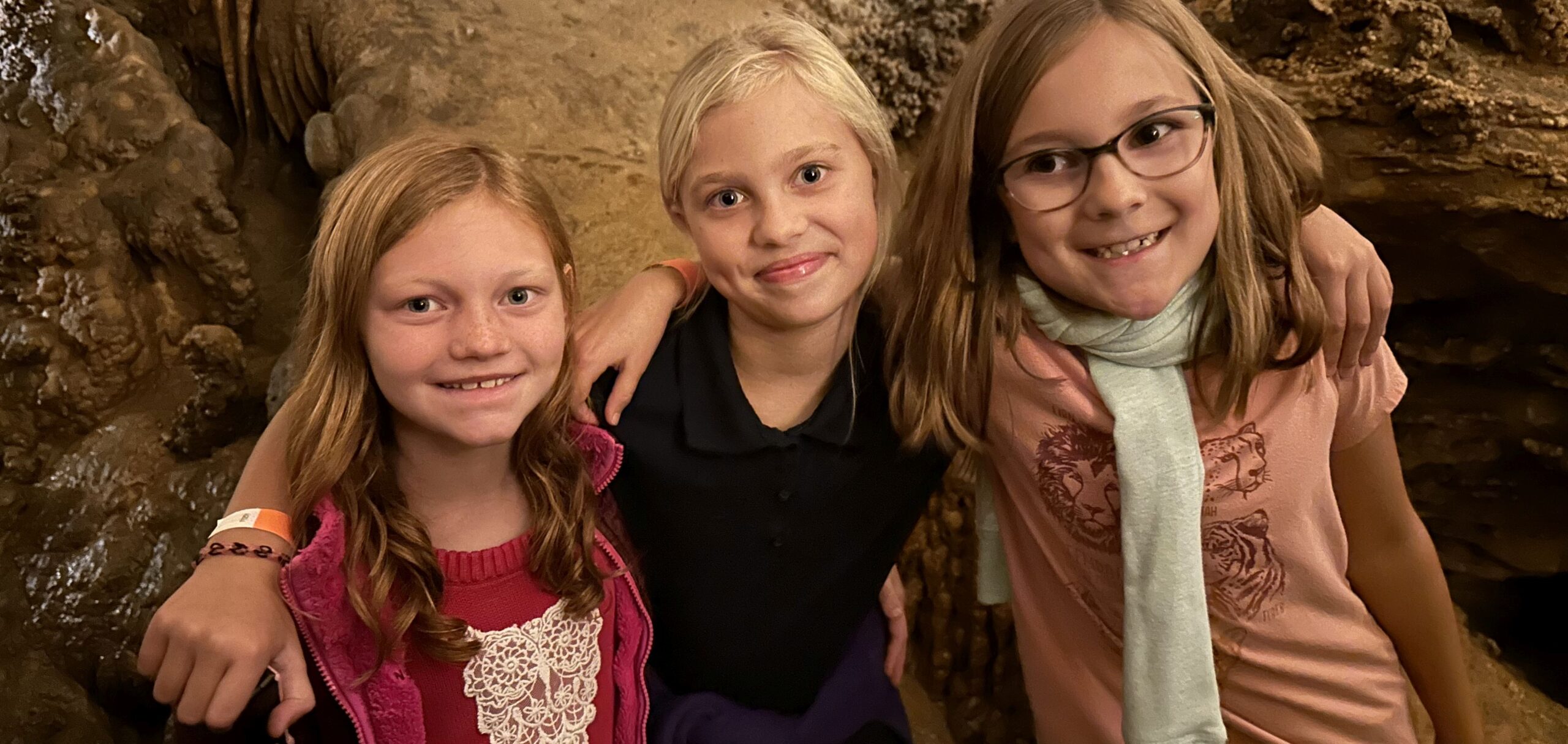 Three students in a cavern